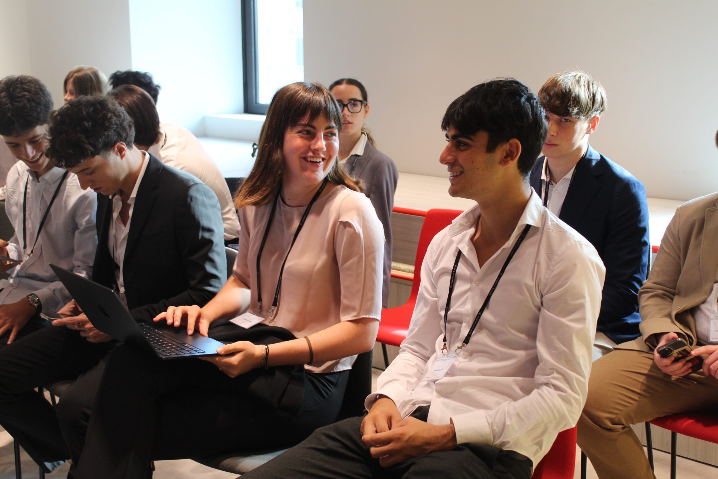 Students with lanyards laughing together during a workshop