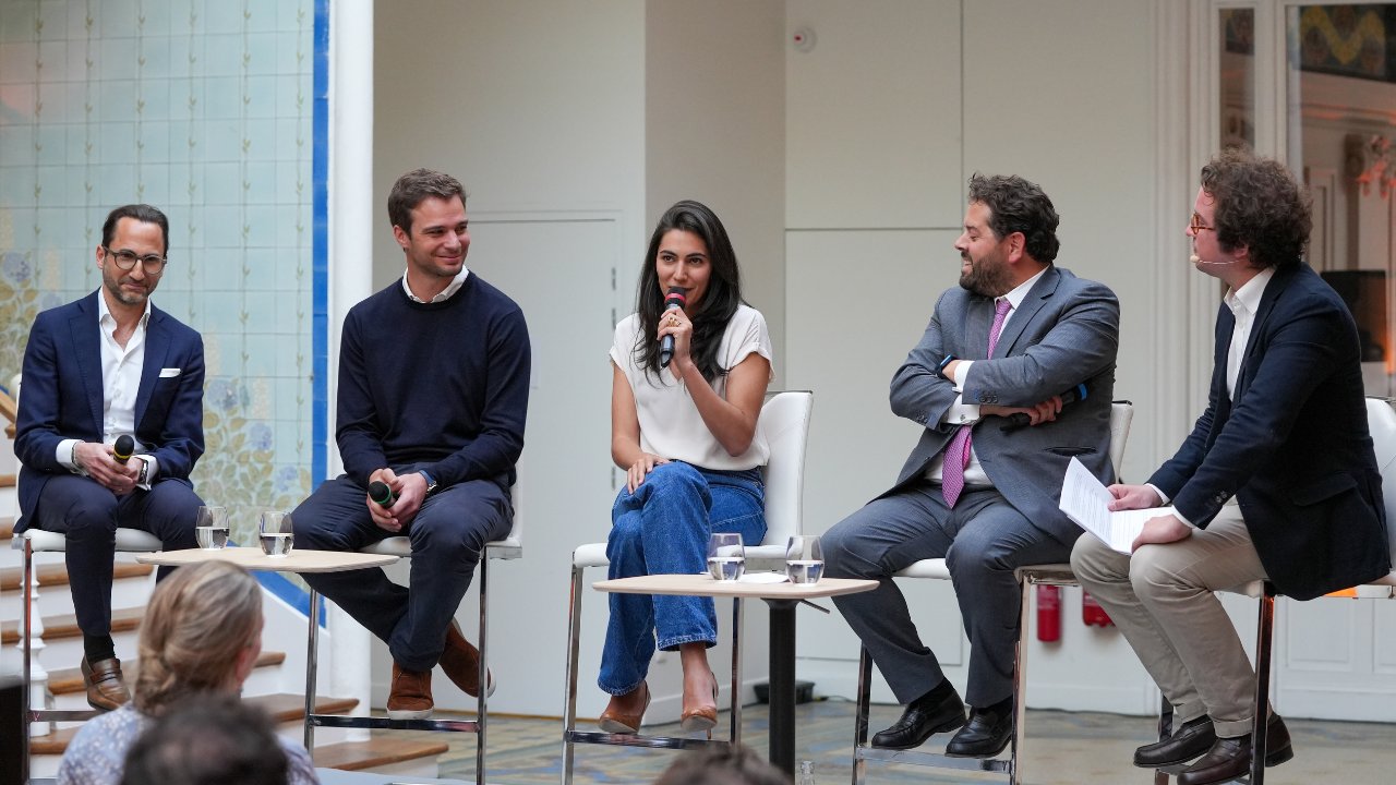 Panel discussion with five speakers on stage